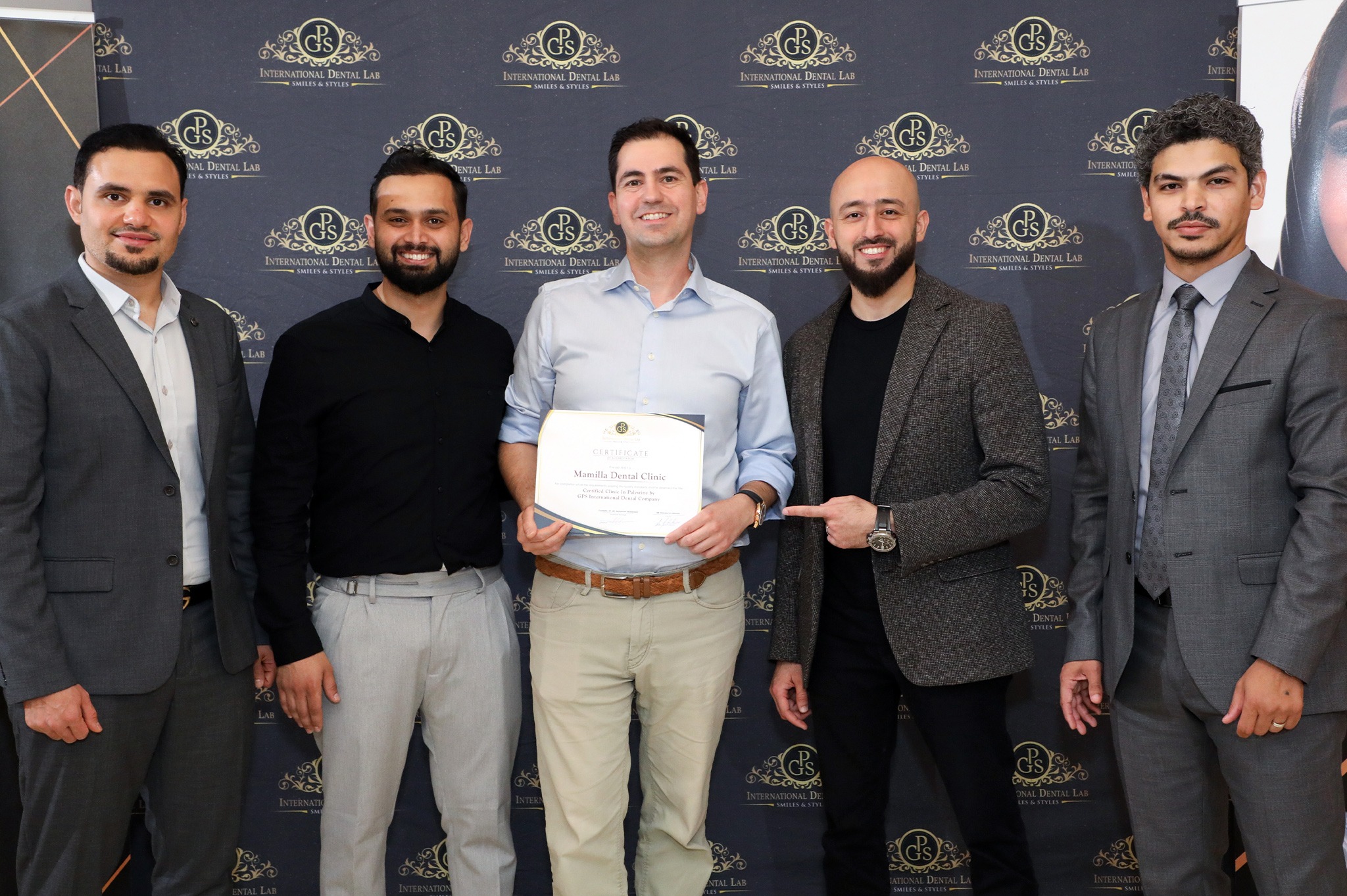 Dr. Nashashibi receiving GPS International Dental Lab certificate for Mamilla Dental Clinic